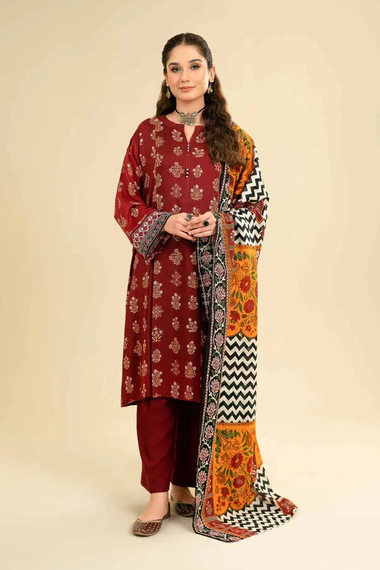 Woman wearing a maroon kurta with a colorful dupatta on a beige background