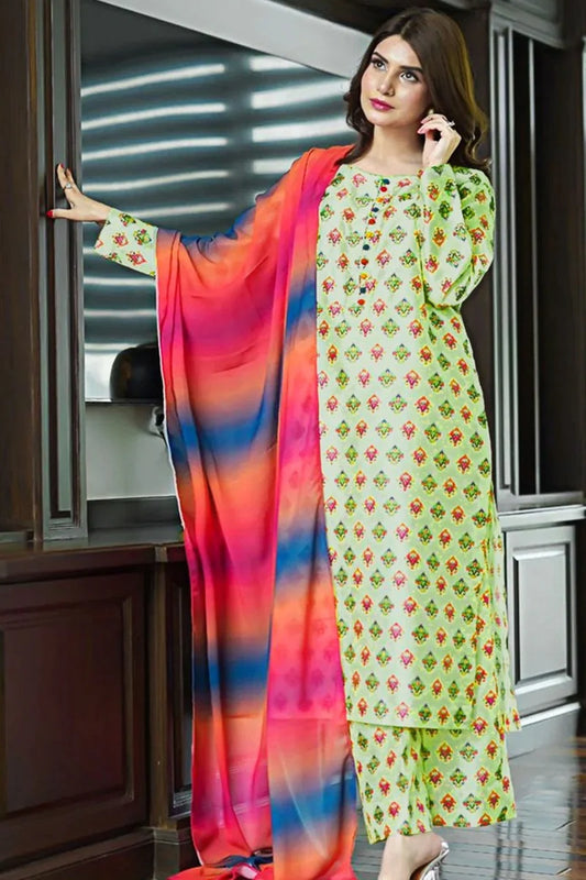 Woman wearing a floral dress with a colorful dupatta in an indoor setting