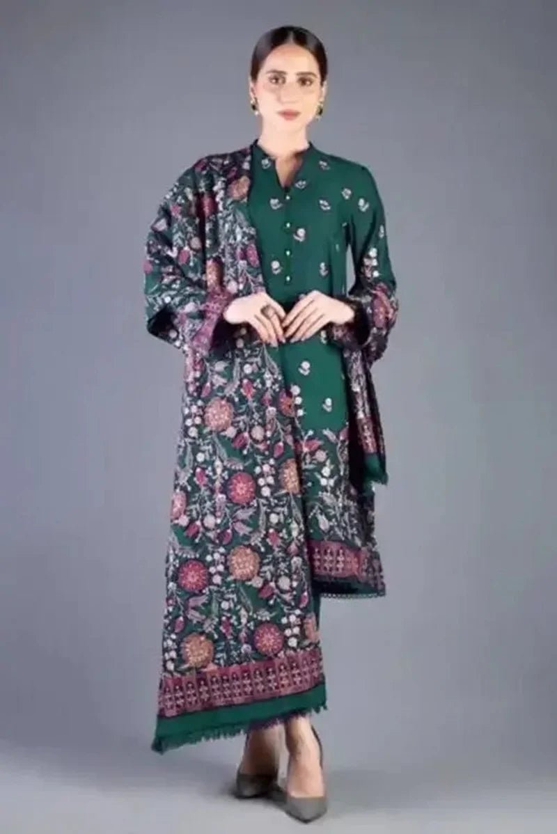 Woman wearing a green traditional outfit with a floral patterned shawl on a gray background