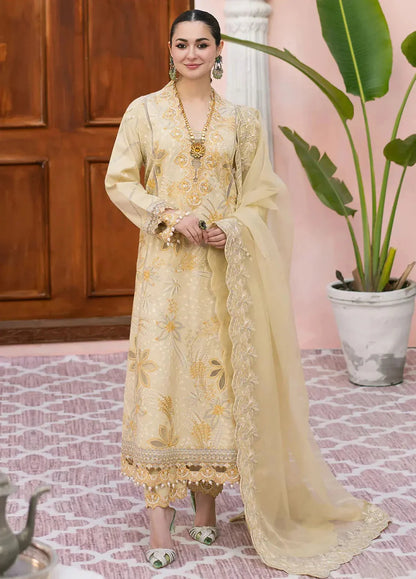 Woman in a traditional outfit with floral patterns standing indoors.