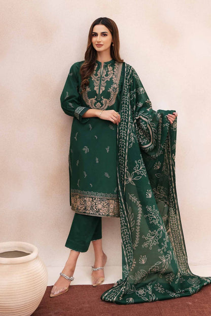 Woman wearing a green embroidered outfit with a matching dupatta against a beige background